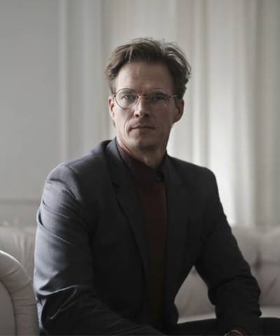 well dressed businessman sitting on sofa